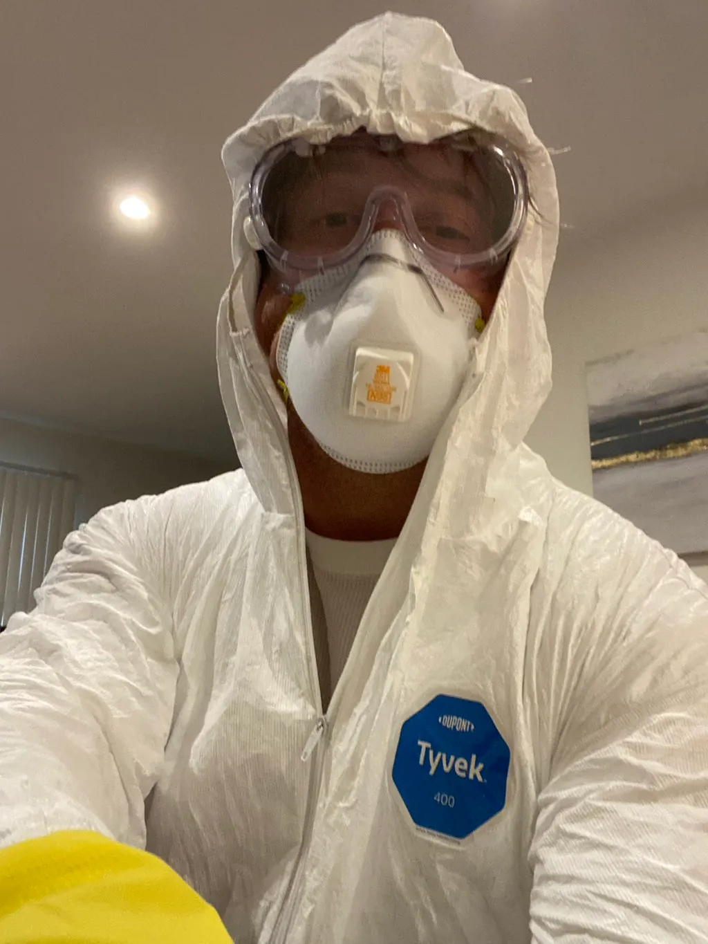 Mold & Allergy technician in Tyvek 400 suit and N95 respirator before entering an active remediation zone.